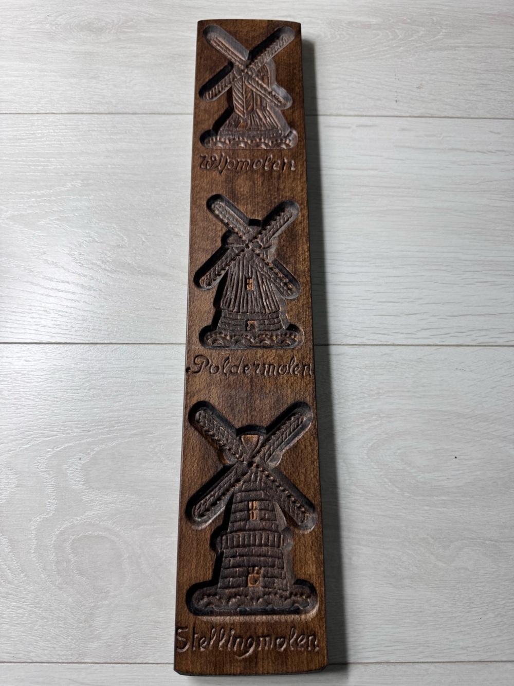 Carved wood cookie mold featuring three Dutch windmills